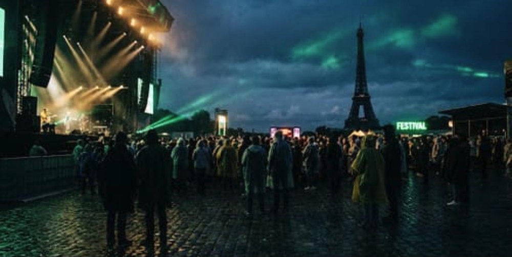 Paris show: festival crowd at dusk with the Eiffel Tower behind